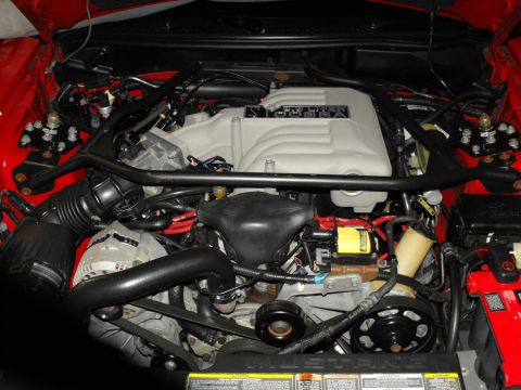 1994 Ford Bronco - Close-up view of a car's engine bay, showing various components and wiring.