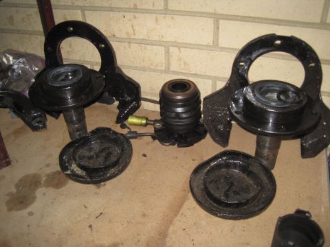 1979 Ford Bronco - Various suspension parts laid out on a floor, with a watermark for Supermotors.net visible.