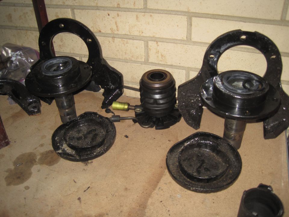 Several black suspension components, including spindle assemblies and a clutch slave cylinder