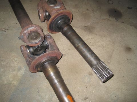 1979 Ford Bronco - Close-up of two used driveshafts, showing wear and rust on the components.
