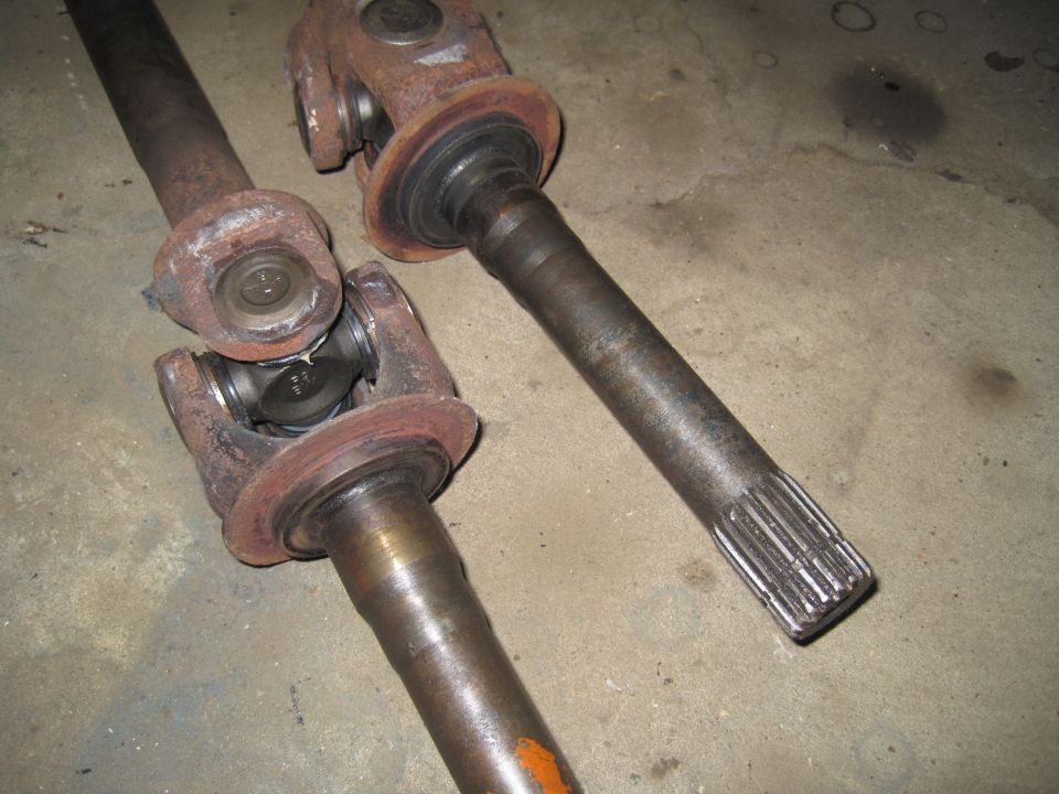 Two rusty driveshafts with universal joints
