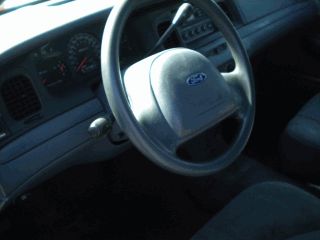 2002 Ford Crown Victoria - The interior of a 2002 Ford Crown Victoria is shown, including the dashboard and steering wheel.