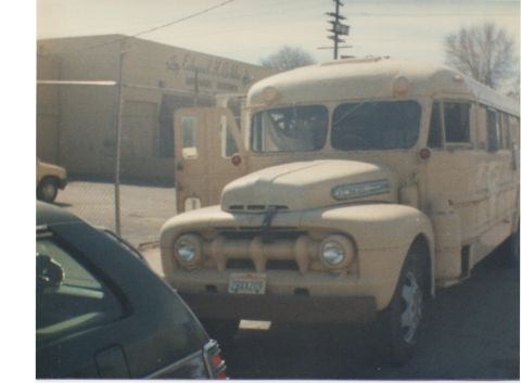 1968 Ford Mustang - A vintage bus, modified with a 1950s truck front, sits parked in front of a building.