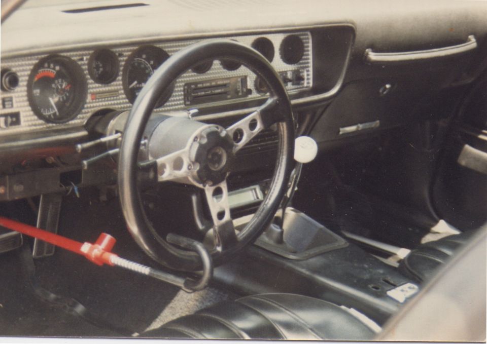 Interior view of a 1970 Pontiac Firebird with aftermarket steering wheel and shifter