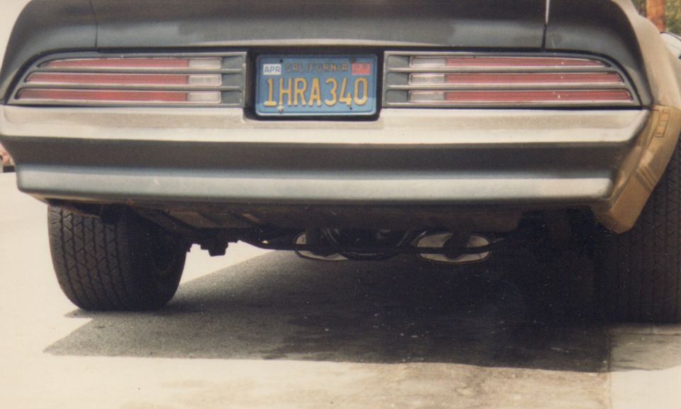 Rear view of a 1977 Pontiac Firebird Trans Am with California plates 1HRA340 and dual exhaust pipes