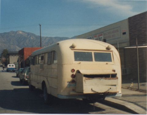 1968 Ford Mustang - Rear view of a yellow school bus with a makeshift wooden bumper and chain.