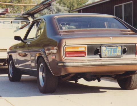 1968 Ford Mustang - This brown coupe, likely from the early 1970s, is viewed from the rear with a California license plate visible.