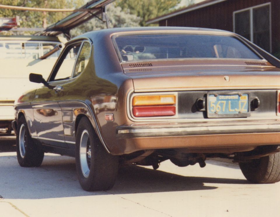 Brown coupe with a black stripe across the rear, California license plate 567 LJZ, and chrome trim
