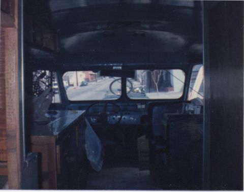 1968 Ford Mustang - The interior of a vehicle shows a view of a street through the windshield, with the dashboard and steering wheel in the foreground.