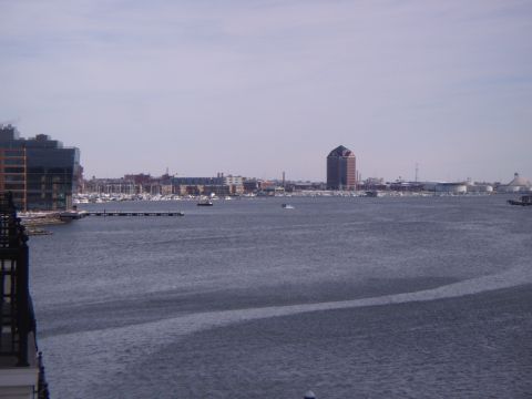 2003 Jeep Wrangler - A wide view of a harbor with boats and city buildings under a cloudy sky.