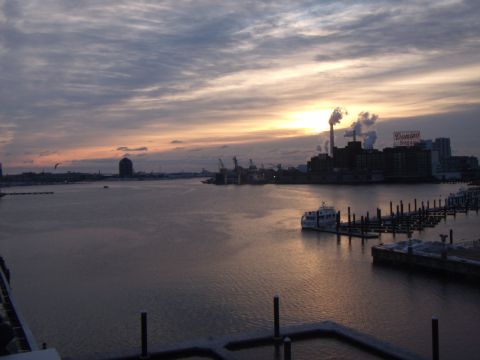 2003 Jeep Wrangler - Sunset over a harbor with boats docked and industrial buildings in the background.