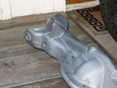 1986 Ford Bronco - Close-up of a silver-painted front axle beam, possibly for a truck or SUV.