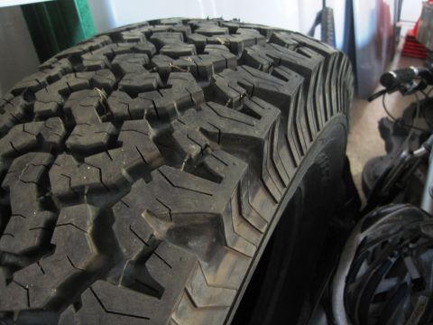 1986 Ford Bronco - A close-up view of a tire tread, with a website address visible in the lower right corner.