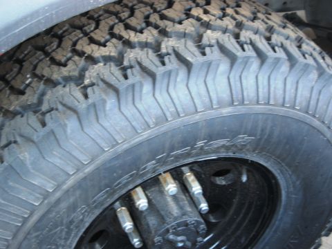 1986 Ford Bronco - Close-up of a BFGoodrich All-Terrain T/A tire mounted on a black wheel.