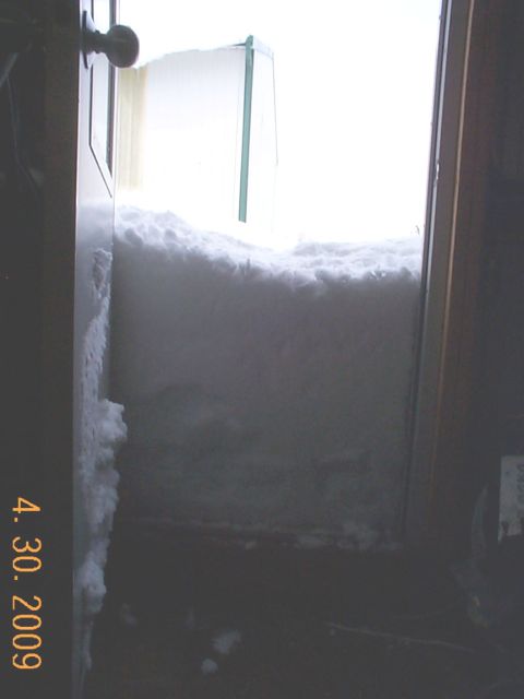 1984 Ford Mustang - A massive snowdrift has completely blocked a doorway, with the date April 30, 2009 visible on the left.