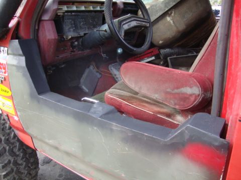 1986 Ford Bronco - The interior of a 1986 Ford Bronco, showing the driver's side door panel and dashboard.