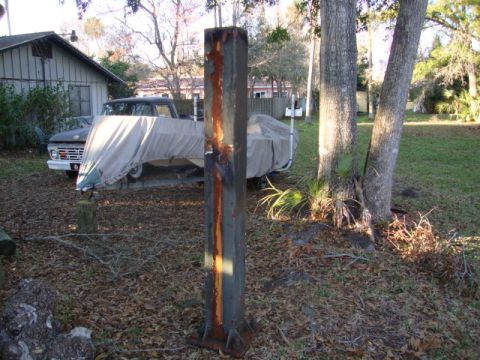 1986 Ford Bronco - A vintage pickup truck is parked next to a boat covered by a tarp in a yard.