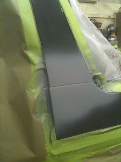 1993 Ford Bronco - A vehicle's tailgate is masked off and being prepped for painting.