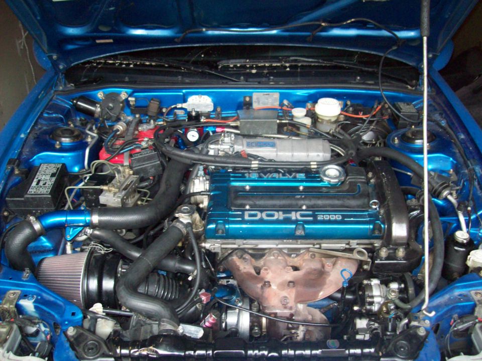 Blue engine bay with DOHC 2000 valve cover and aftermarket air intake