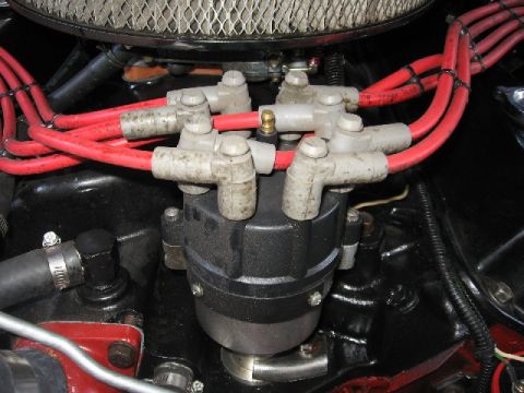 1966 Ford F-100 - The distributor cap and spark plug wires are visible in this engine compartment detail shot.