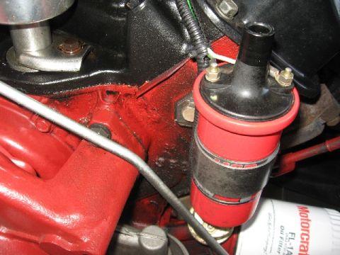 1966 Ford F-100 - Close-up of engine components including an ignition coil and oil filter.