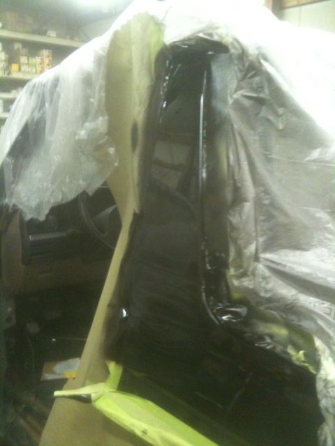1993 Ford Bronco - The interior of a vehicle is covered in plastic sheeting, likely for painting.