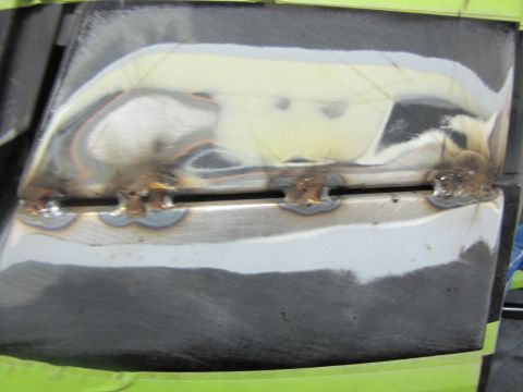 1993 Ford Bronco - Tailgate section undergoing repair, showing fresh welds and primer application.