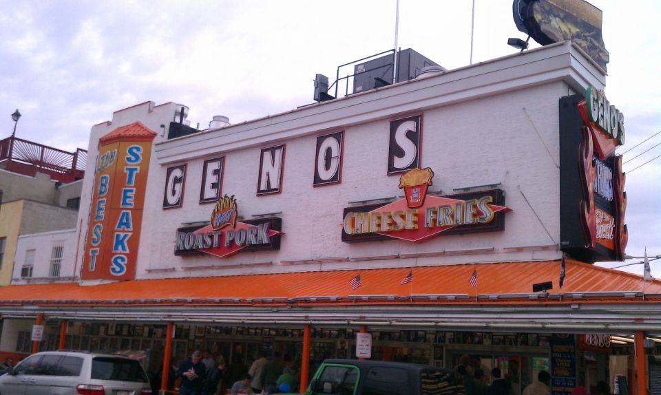Geno's Steaks building with signs for roast pork and cheese fries