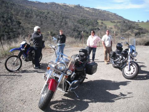 1991 Ford Bronco - A group of people and their motorcycles are gathered on a sunny day in a rural, hilly landscape.