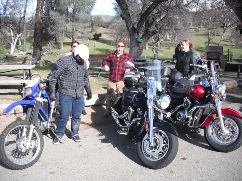 1991 Ford Bronco - A group of people gathered around three motorcycles on a sunny day.