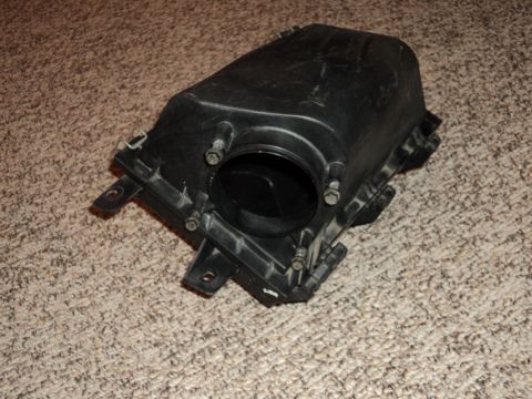 2004 Mercury Grand Marquis - Air intake box for a vehicle, shown on a carpeted surface.
