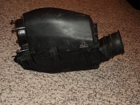 2004 Mercury Grand Marquis - This is an air intake box, likely a replacement part, shown on a carpeted surface.