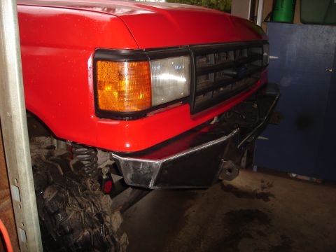 1989 Ford Bronco - Front view of a red 1989 Ford Bronco a custom aftermarket bumper and grille.