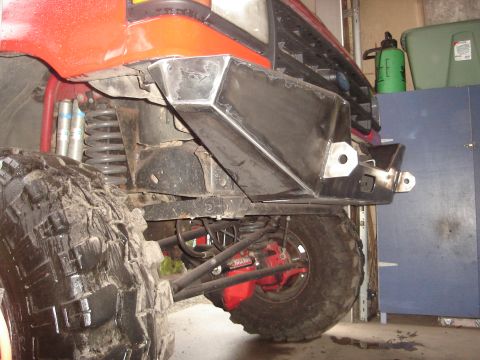 1989 Ford Bronco - Custom front bumper and suspension components visible on a vehicle with large off-road tires.
