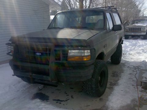 1995 Ford Bronco - This 1995 Ford Bronco is parked in the snow, a brush guard and oversized tires.