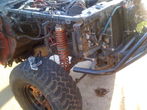 1992 Ford Ranger - The front end of a vehicle is disassembled, revealing its engine and suspension components.
