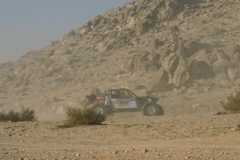 1992 Jeep Wrangler - A custom off-road buggy races through a dusty desert landscape.