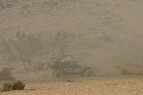 1992 Jeep Wrangler - A custom off-road vehicle navigates a dusty course, possibly during a race event.