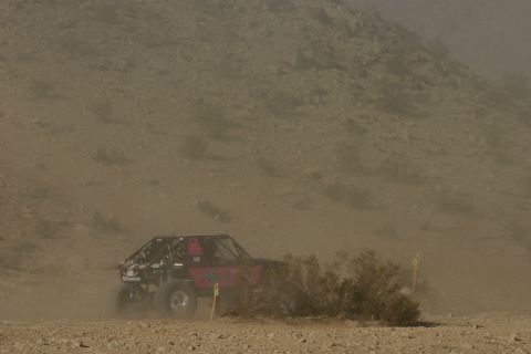 1992 Jeep Wrangler - An off-road buggy navigates a dusty desert course during a race.