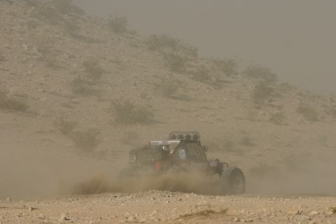 1992 Jeep Wrangler - A buggy races through a dusty desert landscape during an off-road event.