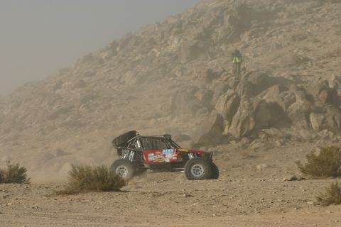 1992 Jeep Wrangler - A custom off-road buggy navigates a dusty desert terrain during a race.