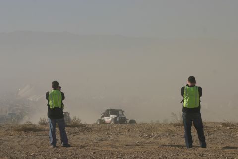 1992 Jeep Wrangler - Two photographers observe an off-road race in a dusty, arid environment.