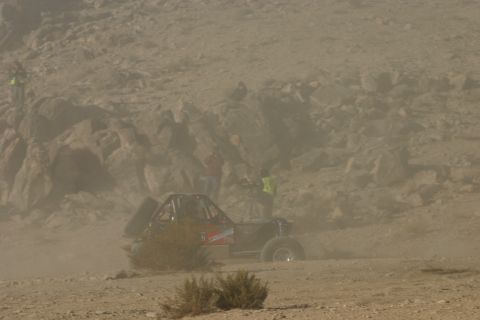 1992 Jeep Wrangler - A buggy navigates a dusty desert course during an off-road event.