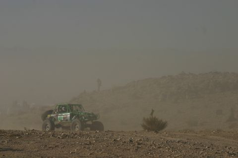 1992 Jeep Wrangler - Off-road buggy races through a dusty desert landscape during an event.