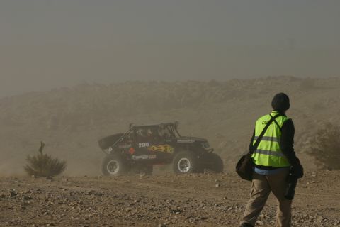 1992 Jeep Wrangler - A buggy races across a dusty desert terrain during an off-road event.