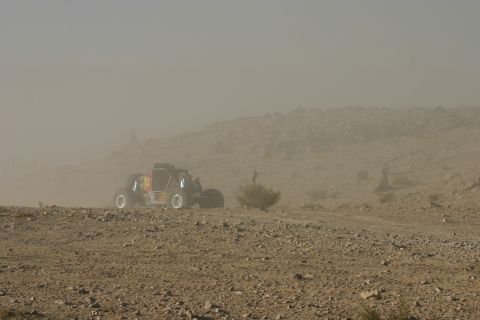 1992 Jeep Wrangler - A single buggy navigates a desolate, dusty landscape under a hazy sky.