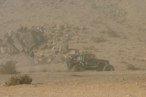 1992 Jeep Wrangler - A modified off-road buggy navigates a dusty desert terrain during an event.