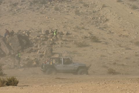 1992 Jeep Wrangler - A silver Jeep Wrangler, number 80, navigates a dusty desert terrain during an off-road event.