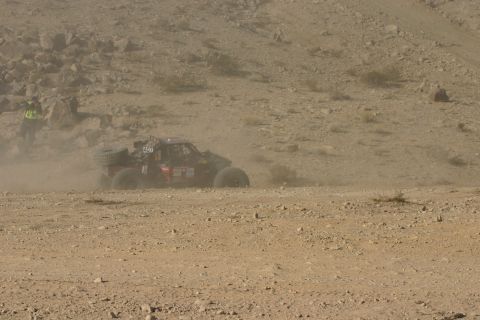 1992 Jeep Wrangler - A lone off-road buggy navigates a dusty desert terrain during a race event.