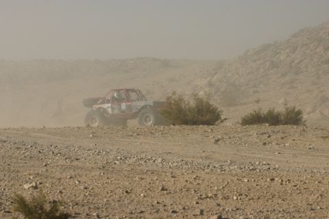 1992 Jeep Wrangler - A custom off-road buggy navigates a dusty, rocky course during a race event.